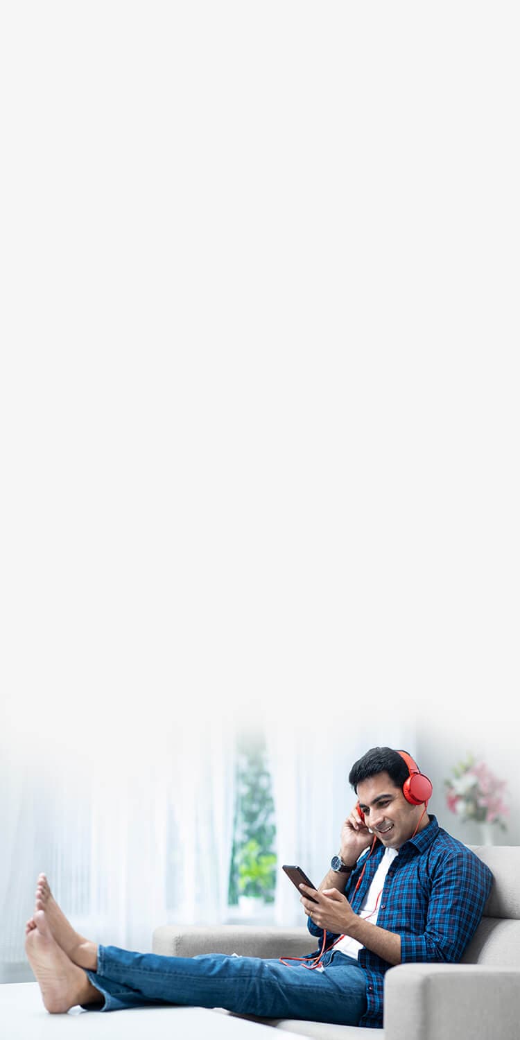 Woman sitting on a couch with a dog and using a laptop